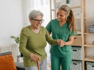 CareOClock caregiver helping a senior walk
